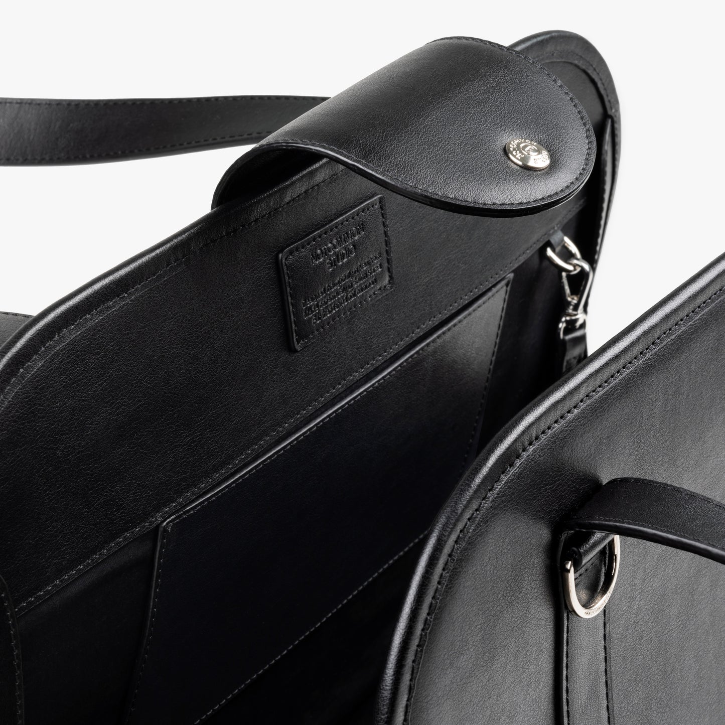 Close-up of NOTCOMMON STUDIO's Companion Tote Bag, showcasing its sleek black recycled leather, detailed craftsmanship, and custom hardware accents.