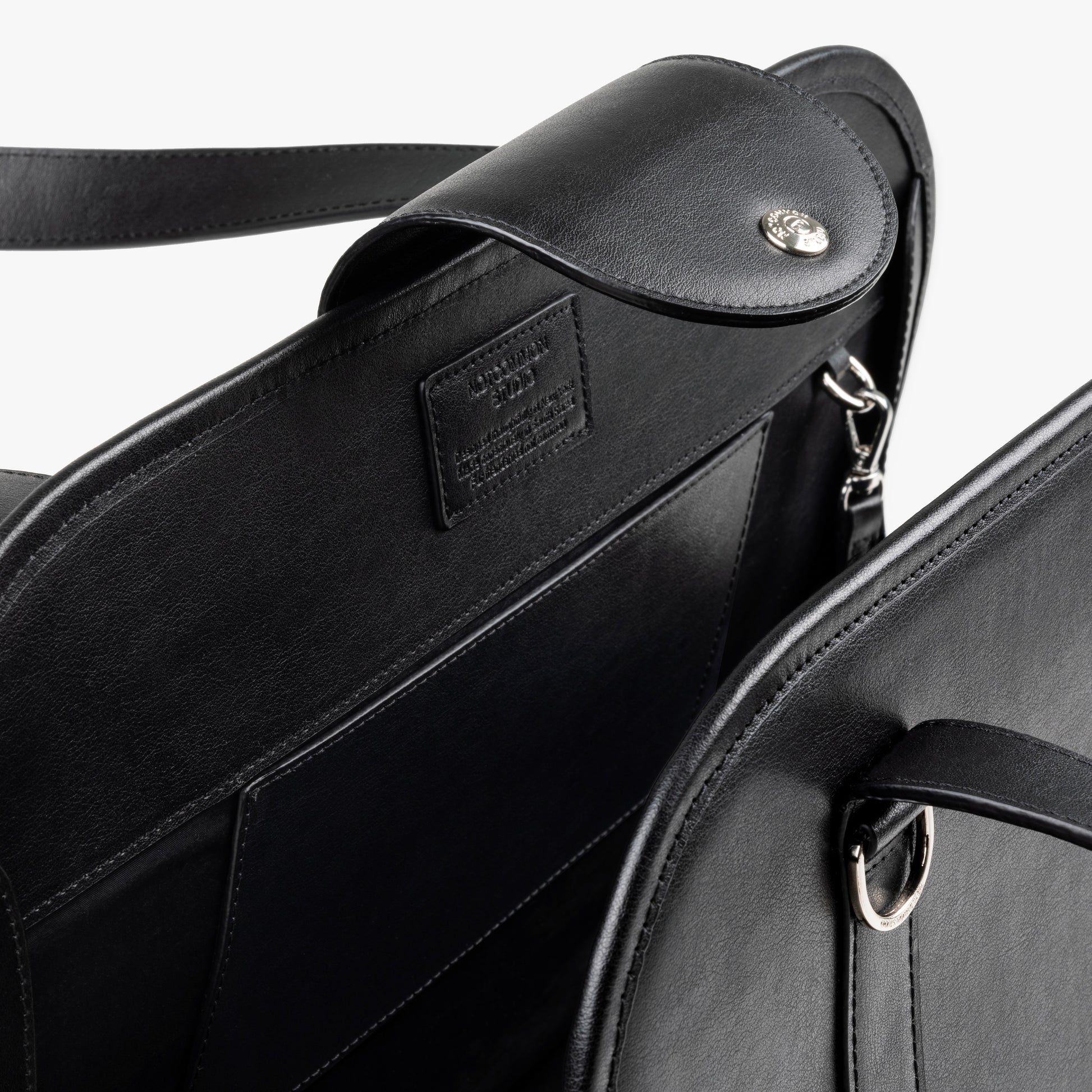 Close-up of NOTCOMMON STUDIO's Companion Tote Bag, showcasing its sleek black recycled leather, detailed craftsmanship, and custom hardware accents.
