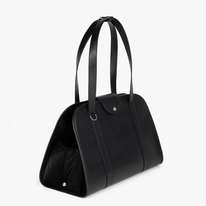 Diagonal view of NOTCOMMON STUDIO’s Companion Tote Bag, featuring a sleek silhouette, structured design, and pet-friendly opening for comfort.