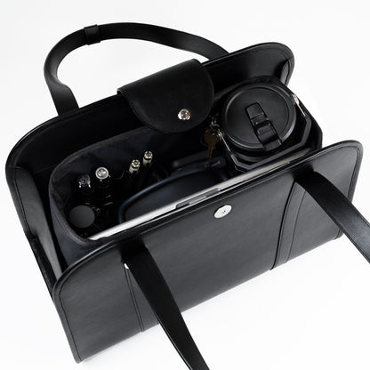 NOTCOMMON STUDIO’s Companion Tote Bag with an inner organizer, neatly storing daily essentials like a laptop, pens, a travel mug, and accessories.